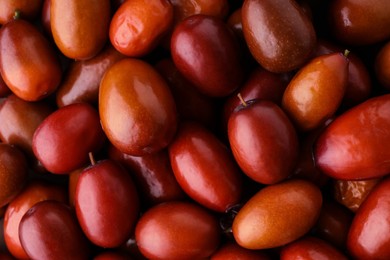 Photo of Heap of ripe red dates as background, closeup