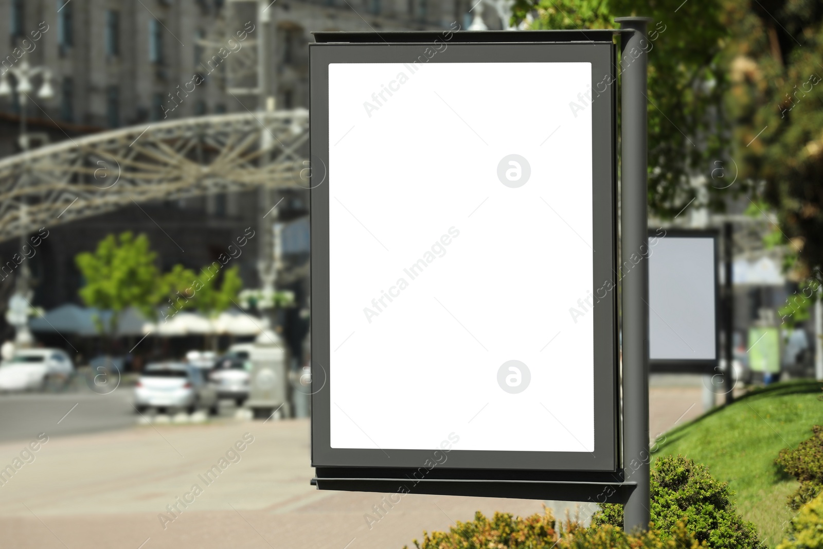 Photo of Blank advertising board on city street. Mockup for design