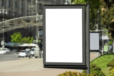 Photo of Blank advertising board on city street. Mockup for design