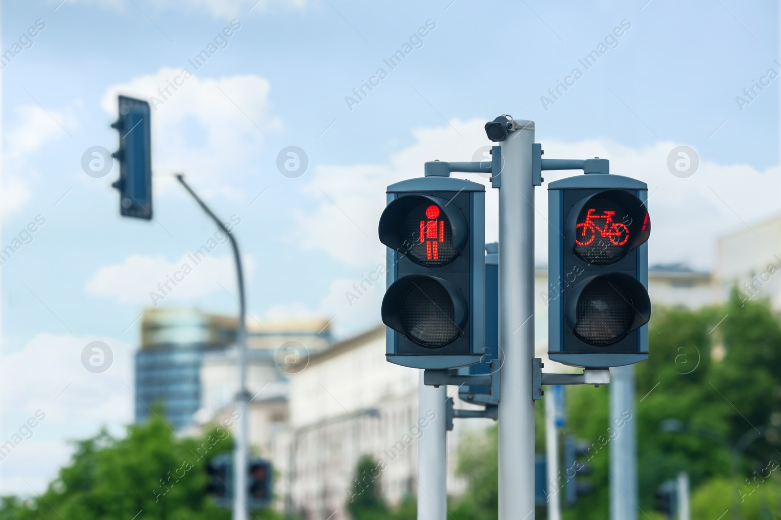 Photo of Pedestrian and bicycle traffic light on city street, space for text