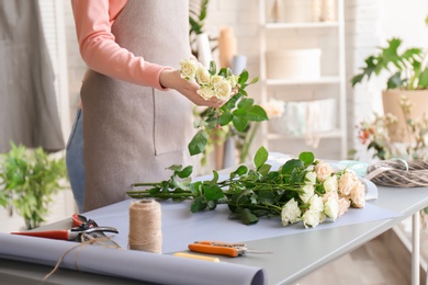 Photo of Female florist creating bouquet at workplace