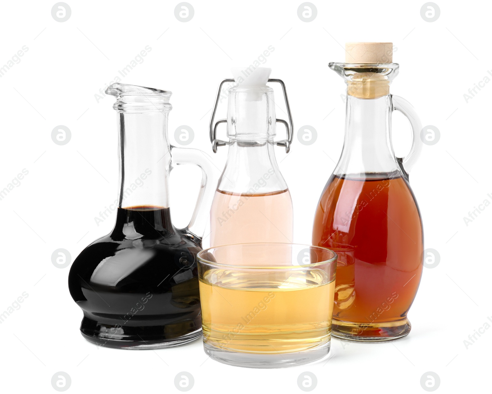 Photo of Different types of vinegar isolated on white