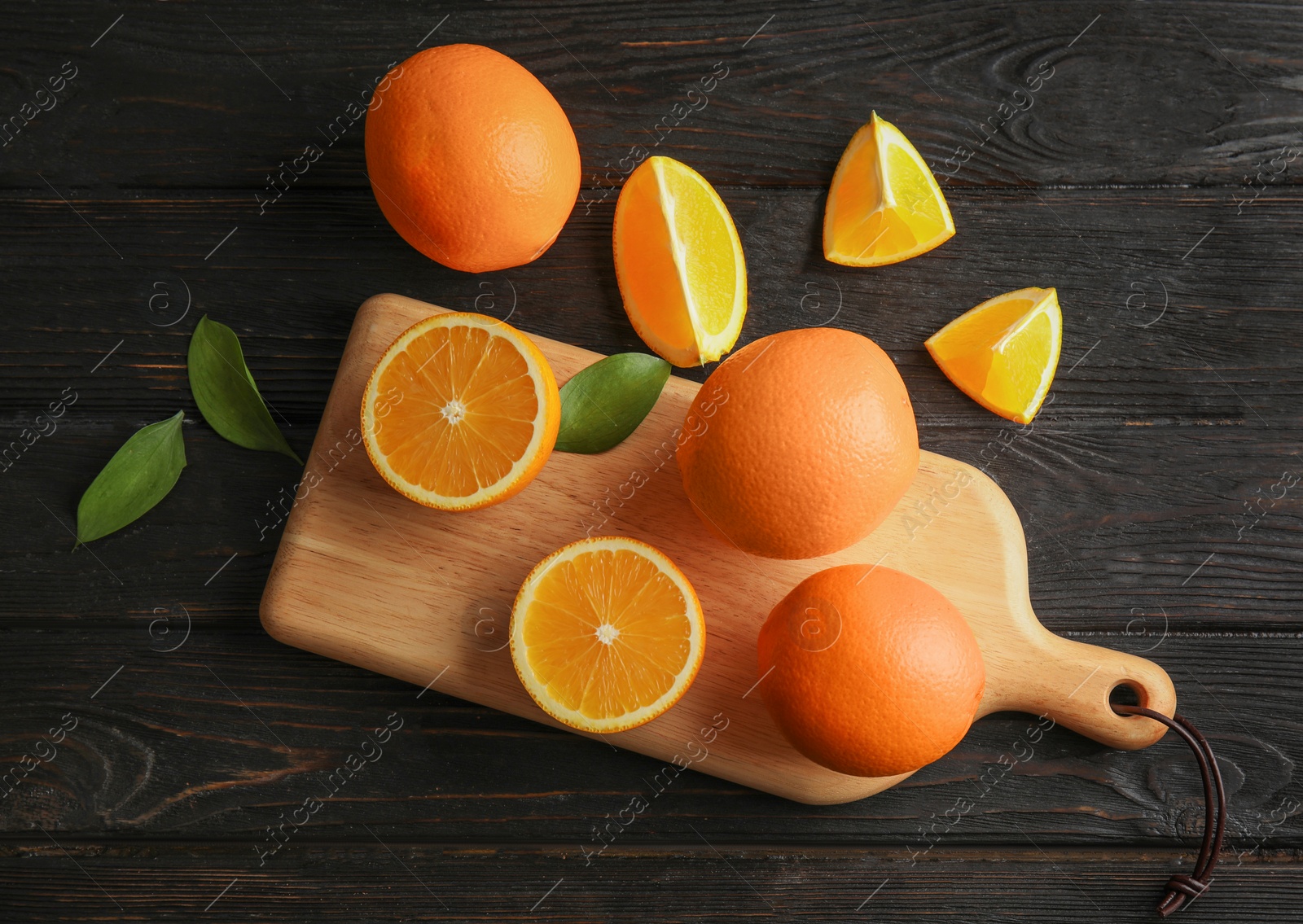 Photo of Fresh juicy oranges on wooden table, top view