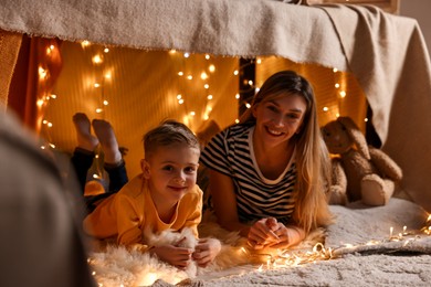 Mother and her son in play tent at home