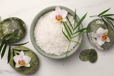 Flat lay composition with spa products and flowers on white marble table