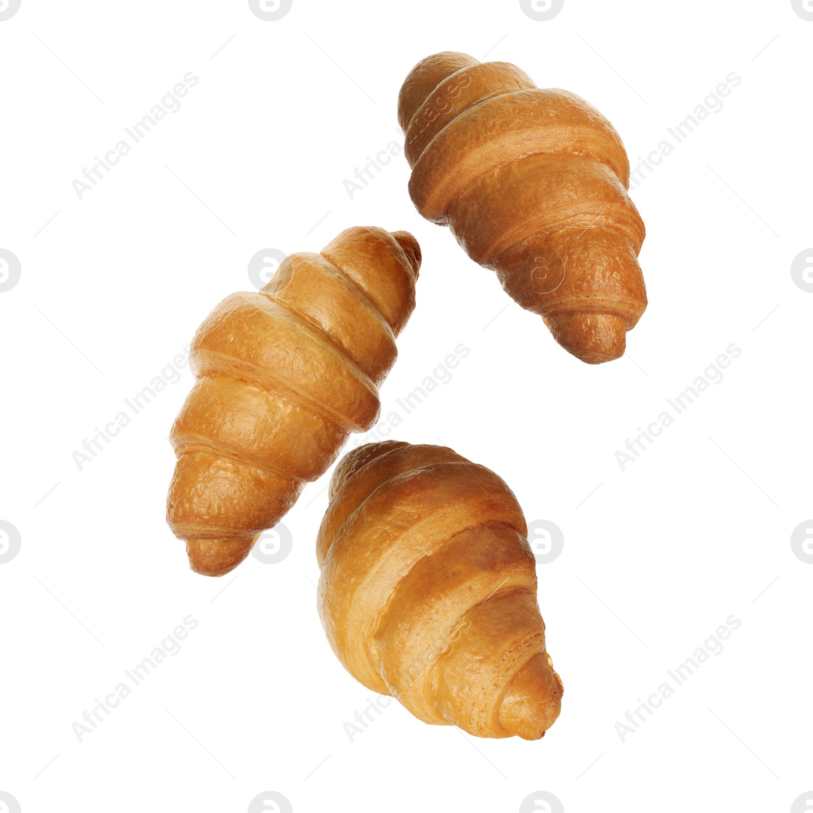 Image of Crusty golden croissants falling on white background