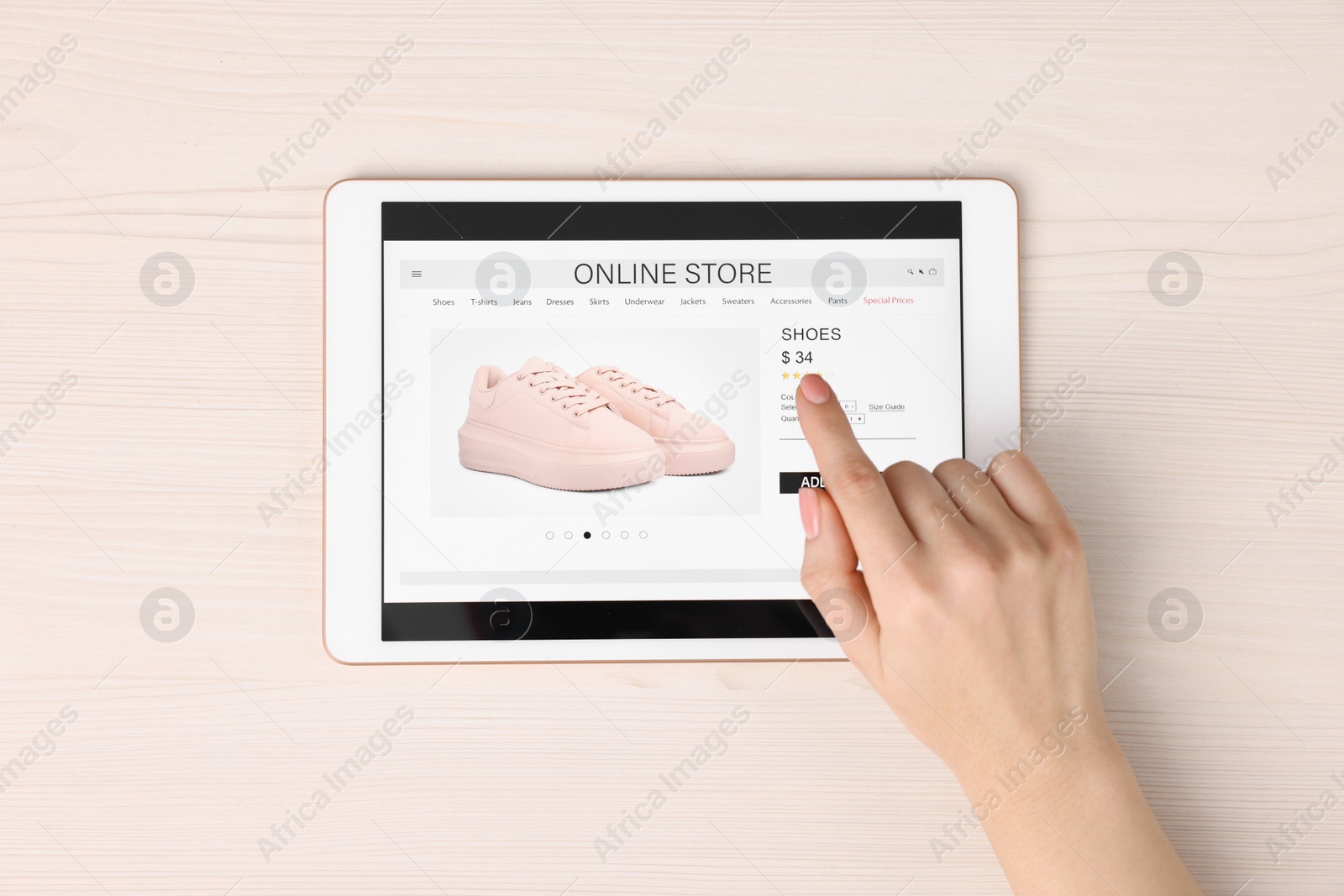 Photo of Woman with tablet shopping online at white wooden table, top view