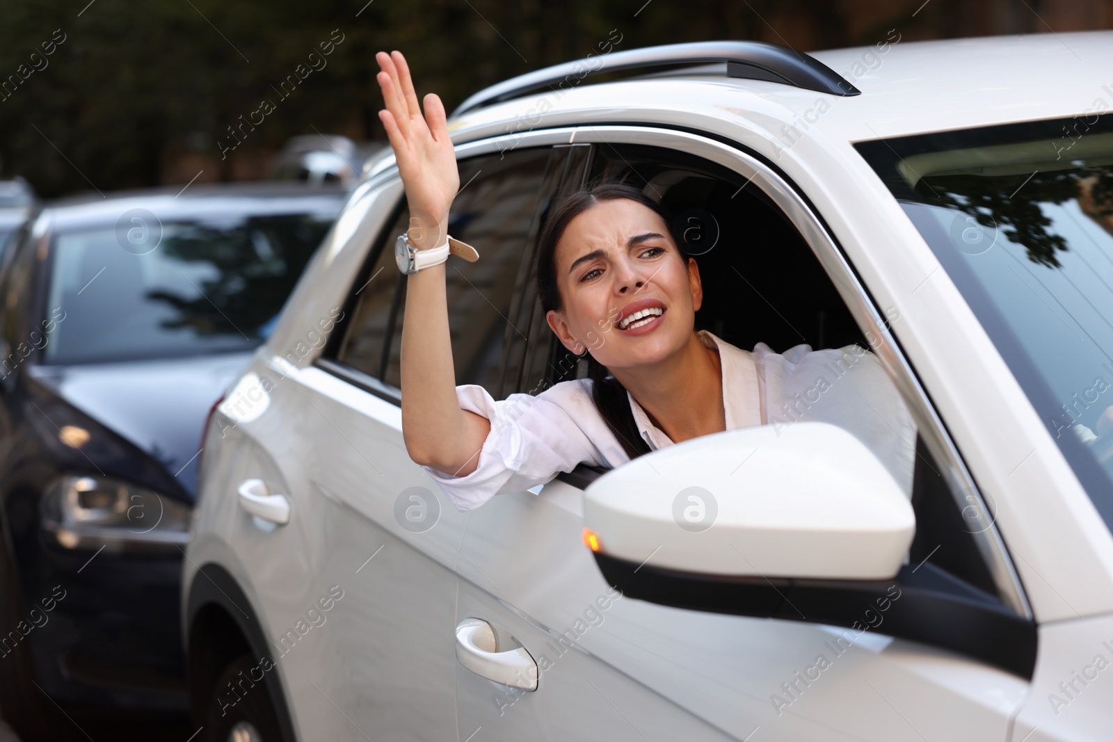 Photo of Angry driver screaming at someone from car in traffic jam