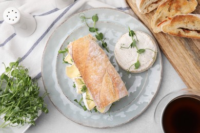 Photo of Tasty brie cheese sandwich served on light grey table, flat lay