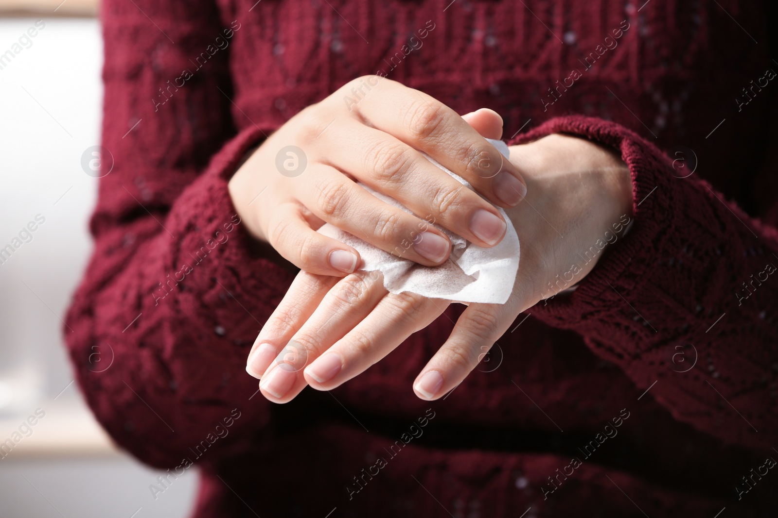 Photo of Woman cleaning hands with paper napkin, closeup