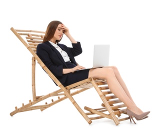 Photo of Young businesswoman with laptop on sun lounger against white background. Beach accessory