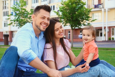 Happy family with adorable little baby outdoors