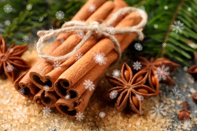 Different spices and fir tree branches on grey table, closeup. Cinnamon, anise, cloves, brown sugar