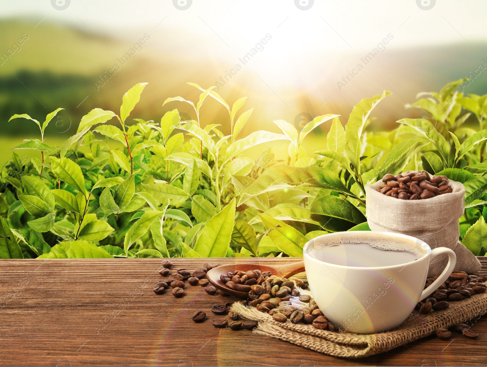 Image of Cup of aromatic hot coffee and beans on wooden table outdoors. Space for text