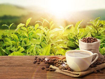 Image of Cup of aromatic hot coffee and beans on wooden table outdoors. Space for text