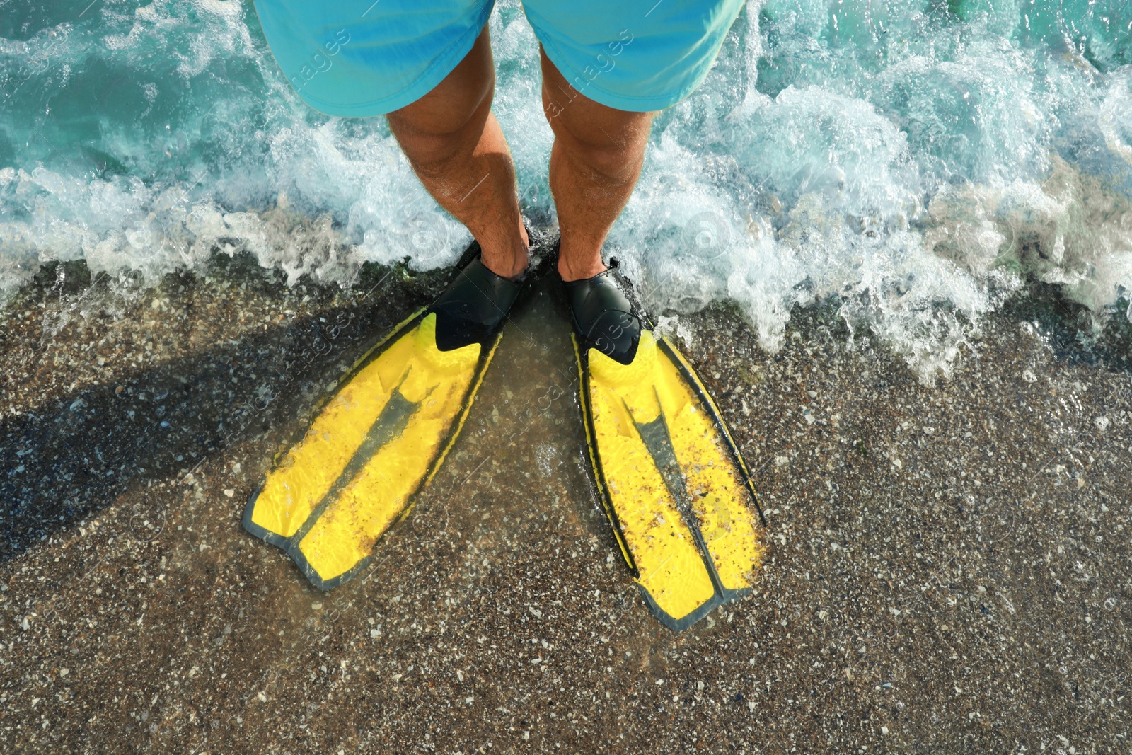 Photo of Top view of man in flippers on beach