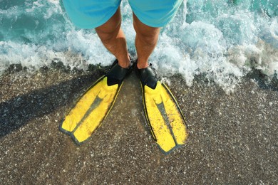 Photo of Top view of man in flippers on beach