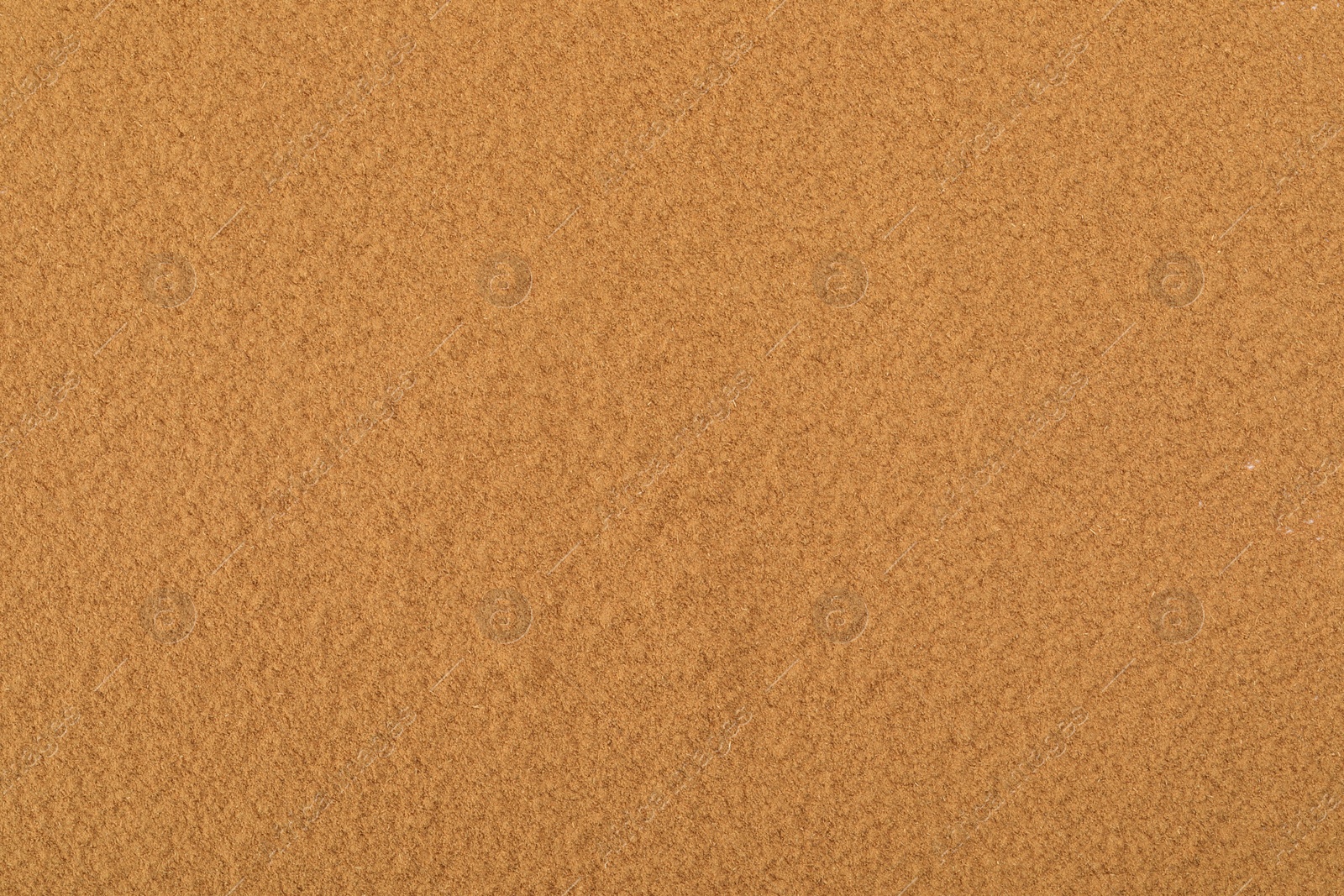 Photo of Dry aromatic cinnamon powder as background, top view