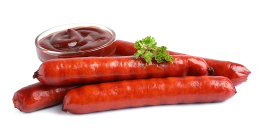 Photo of Delicious grilled sausages and sauce on white background. Barbecue food