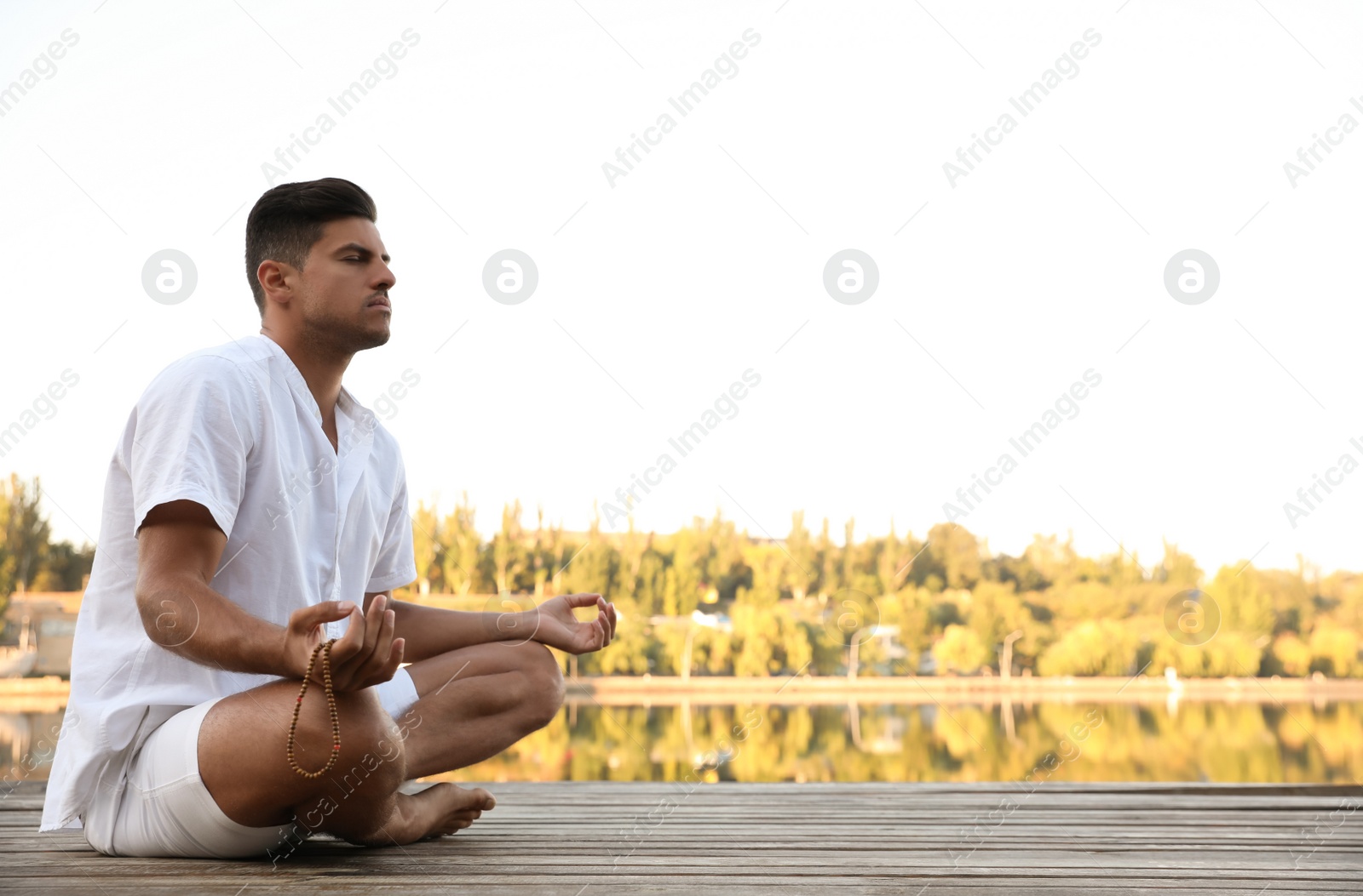 Photo of Man near river at sunset, space for text. Nature healing power