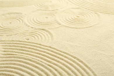 Photo of Zen rock garden. Circle pattern on beige sand