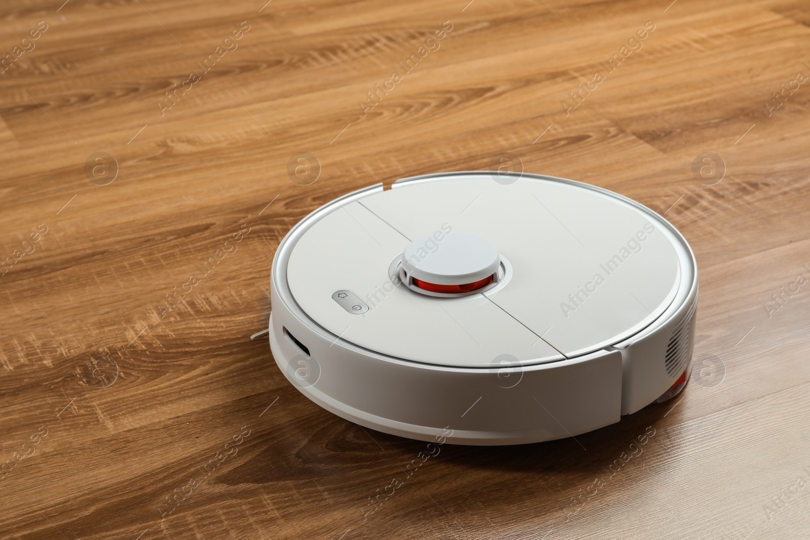 Photo of Robotic vacuum cleaner on wooden floor, space for text