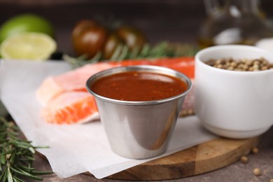 Tasty fish marinade and products on table, closeup