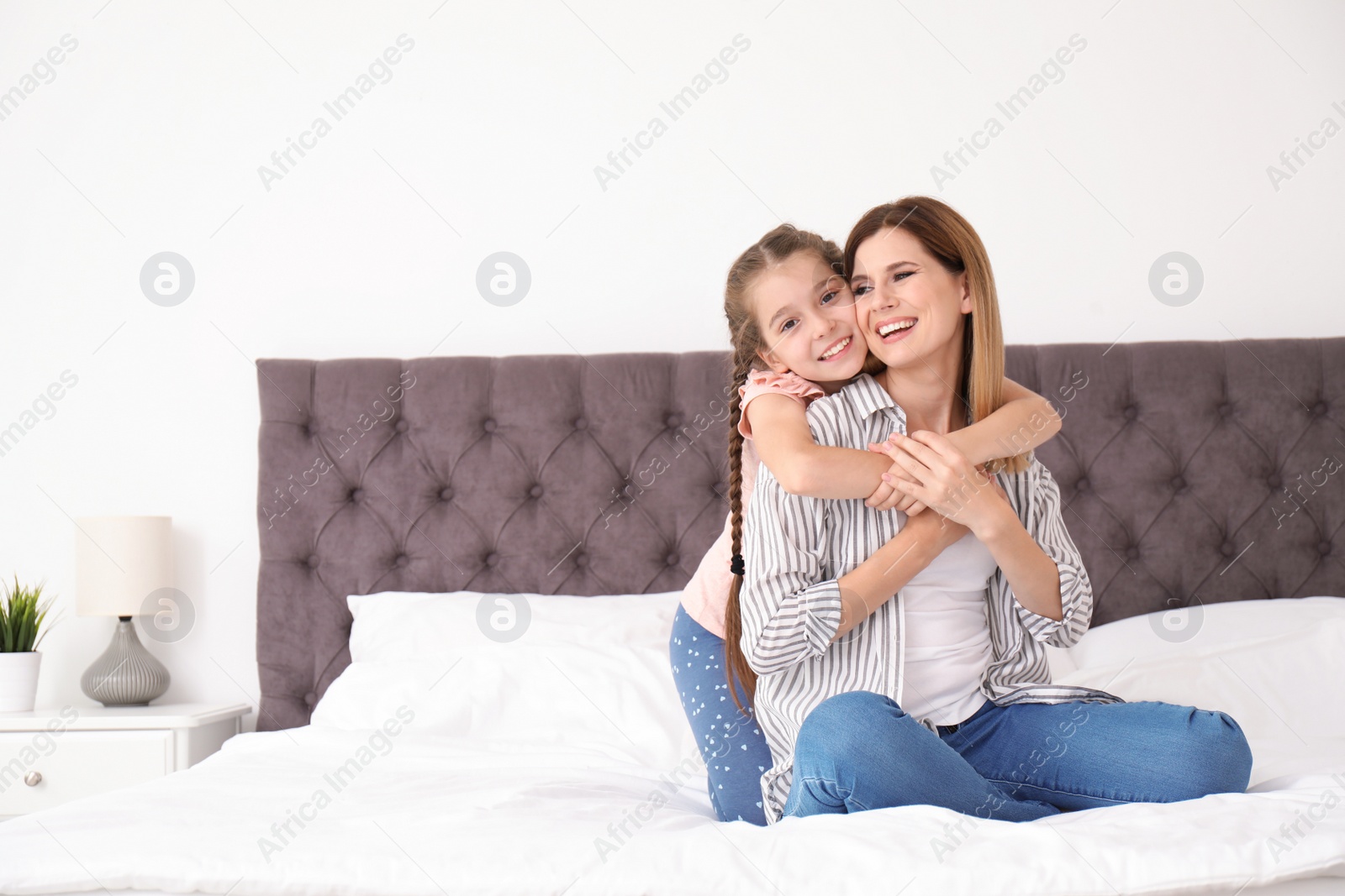 Photo of Mother with cute child in bedroom. Happy family