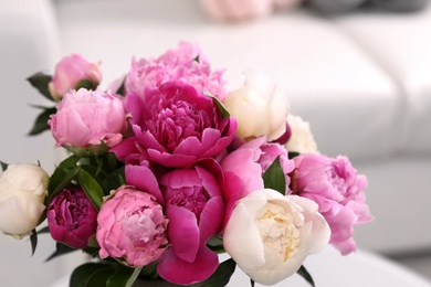 Photo of Bouquet of beautiful peonies in room, closeup