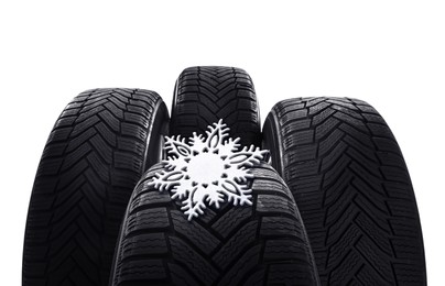 Image of Set of winter tires with snowflake on white background, closeup