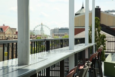 Photo of Observation area cafe. Chairs on terrace against beautiful cityscape