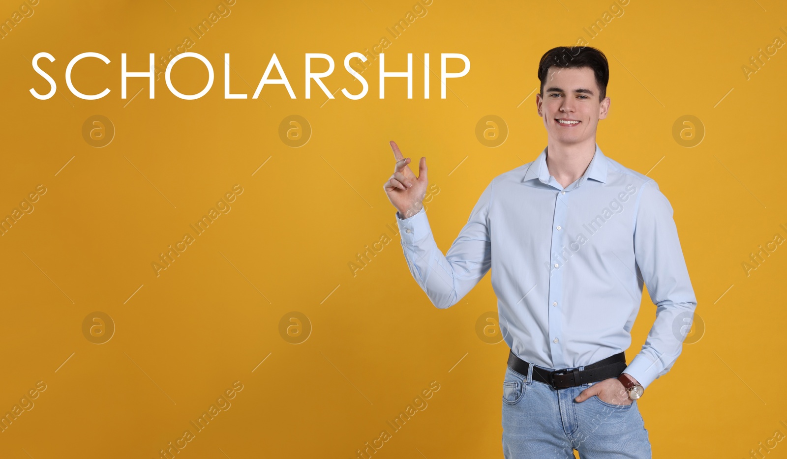 Image of Scholarship concept. Portrait of happy student on yellow background