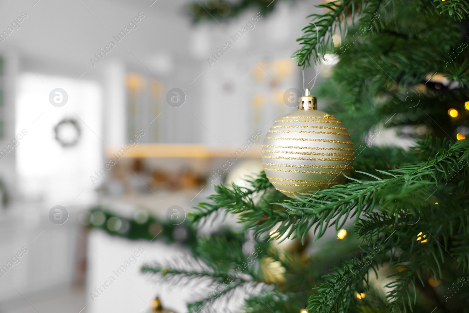 Photo of Closeup view of beautiful decorated Christmas tree in kitchen. Space for text