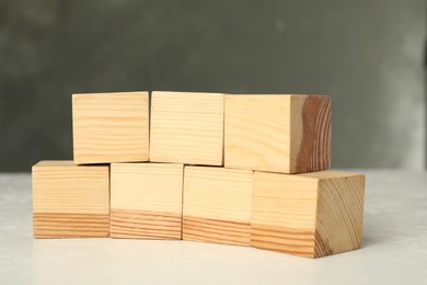 Photo of Wooden cubes with word KEYWORD on white table, closeup
