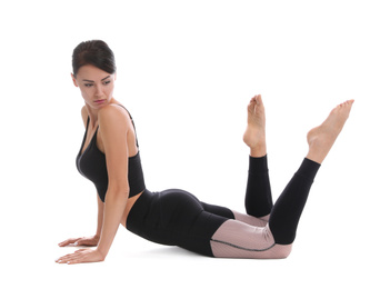 Professional young acrobat exercising on white background