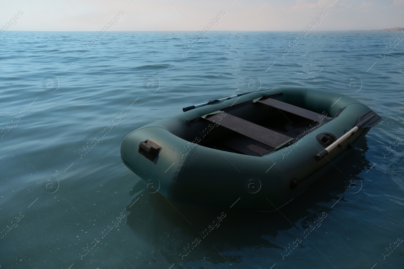 Photo of Inflatable rubber fishing boat floating in sea on sunny day