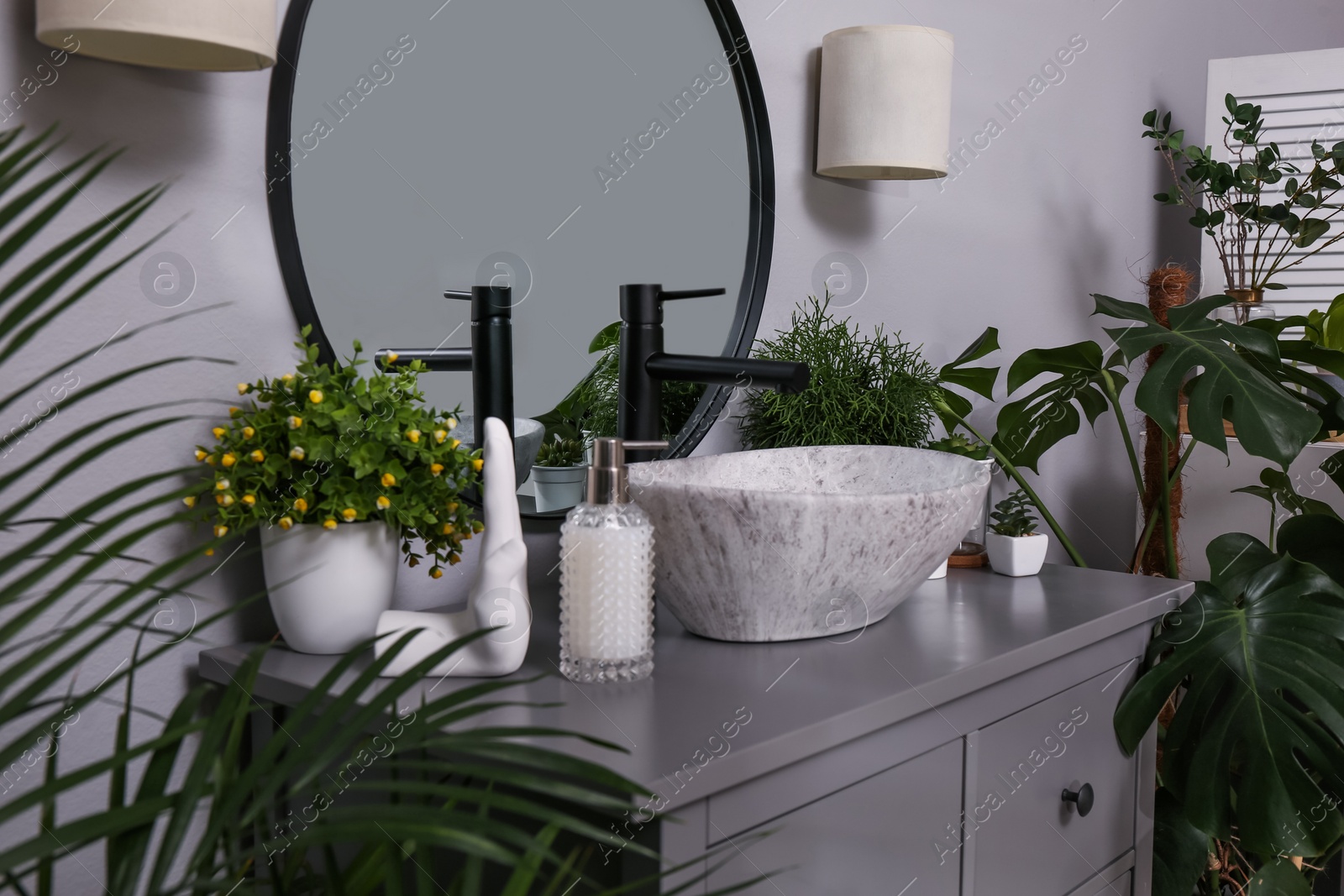 Photo of Stylish sink and beautiful green houseplants in bathroom. Interior design