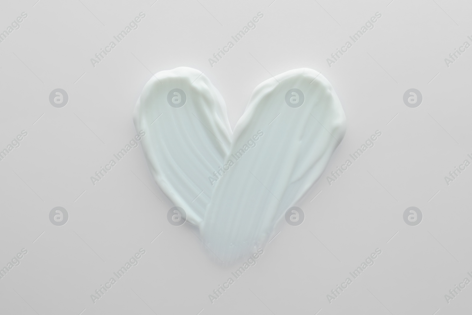 Photo of Sample of facial cream isolated on white, top view