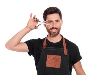 Smiling hairdresser holding scissors on white background