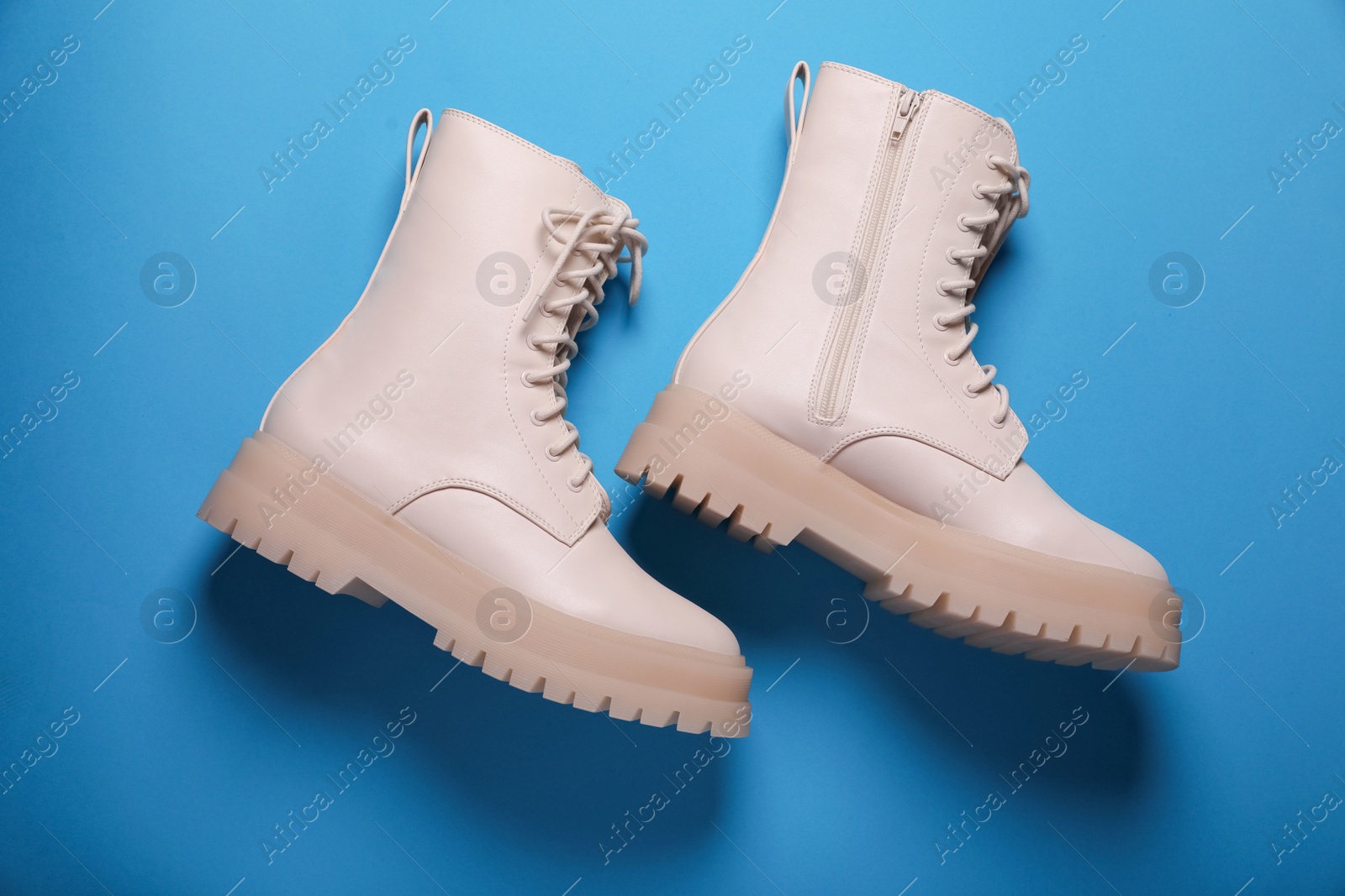 Photo of Pair of stylish leather shoes on light blue background, flat lay