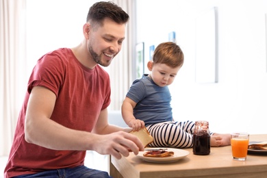 Dad and his son having breakfast in kitchen