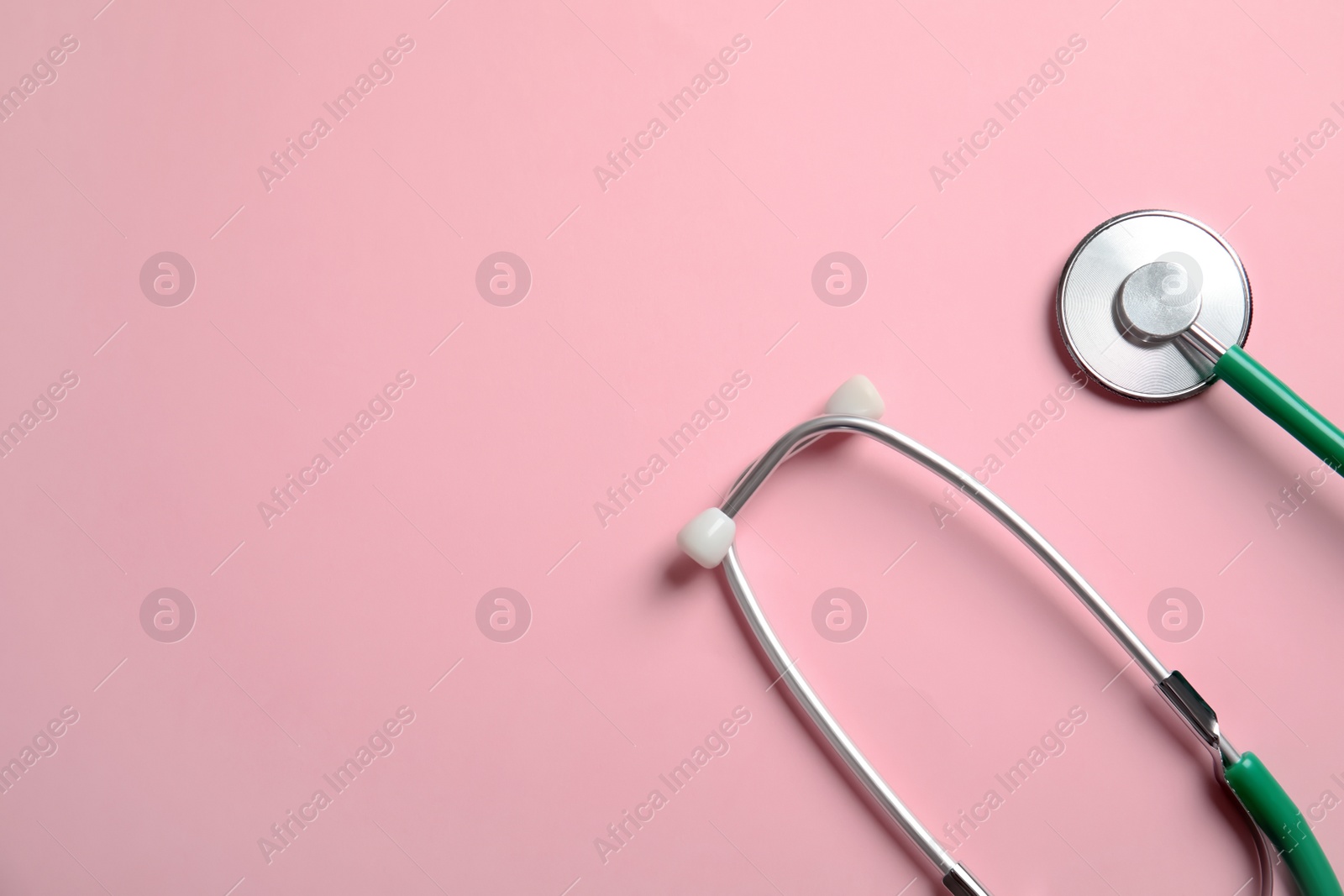 Photo of Stethoscope with space for text on color background, top view. Medical tool