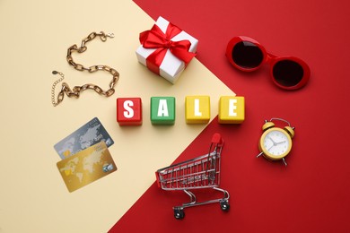 Photo of Flat lay composition with word Sale on color background