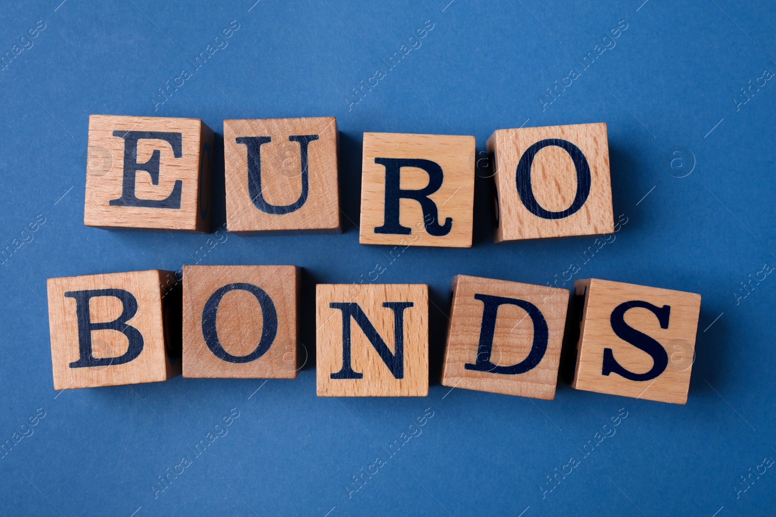 Photo of Word Eurobonds made of wooden cubes with letters on blue background, flat lay