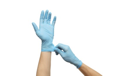 Photo of Doctor wearing light blue medical gloves on white background, closeup