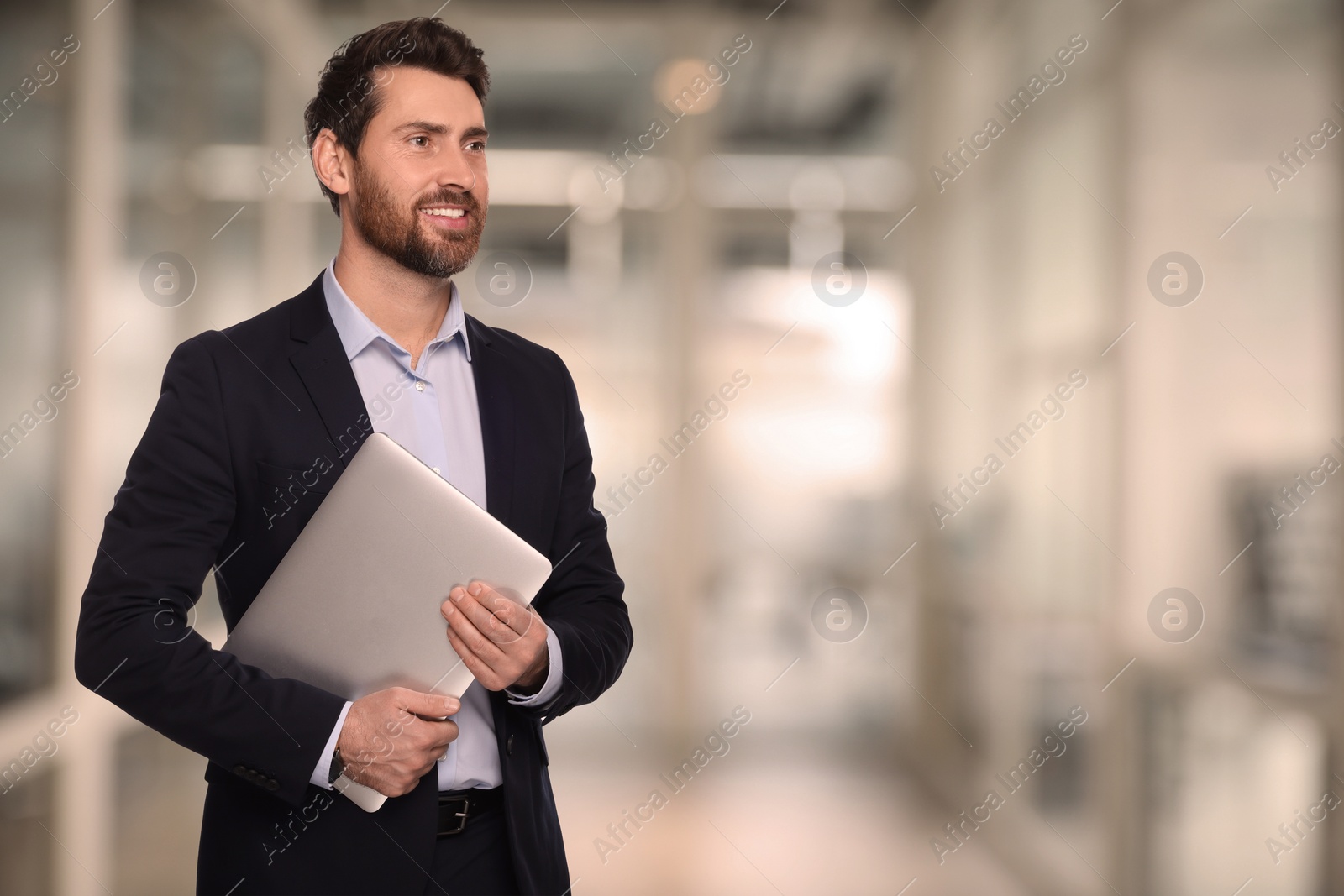 Image of Successful lawyer with laptop on blurred background, space for text