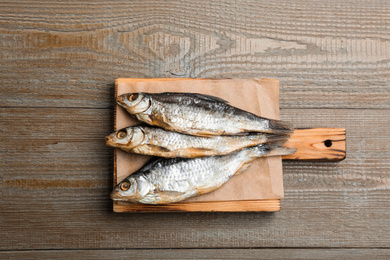 Tasty dried fish with on wooden table, top view