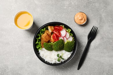 Photo of Healthy takeaway meal served with sauce and juice on light grey table, flat lay