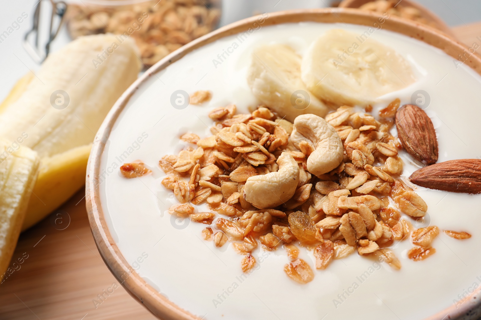 Photo of Bowl with yogurt, banana and granola, closeup