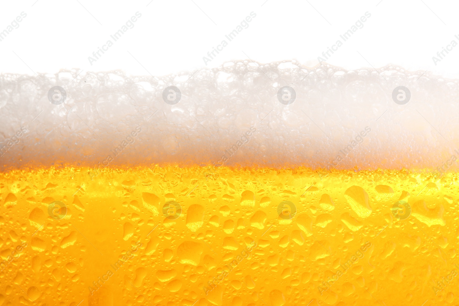 Photo of Glass of tasty cold beer with foam and condensation drops on white background, closeup